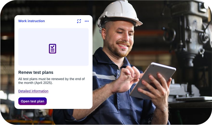 Technician with protective helmet updates test plans via iNFOHUB on the tablet in the workshop