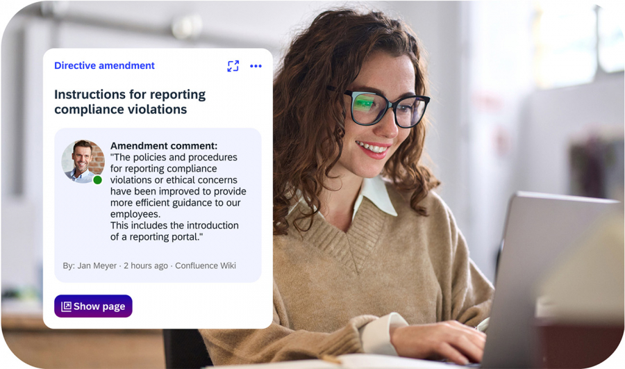 Woman sitting in front of laptop and being informed about new compliance guidelines